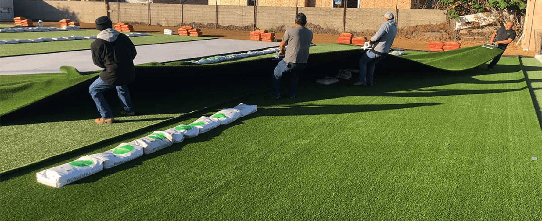 Completed artificial turf installation in a Flower Mound family backyard